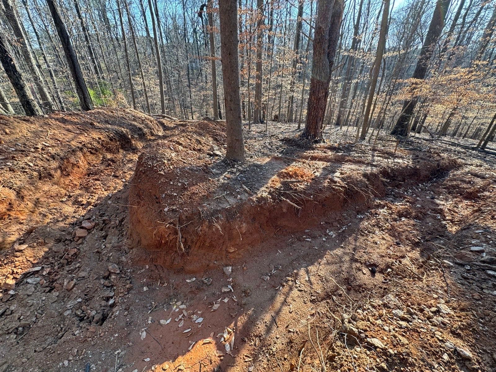 Drainage channel excavated on a wooded residential property